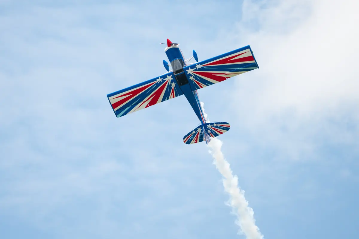 Stunt pilot RJ Gritter leaves a smoke trail on Aug. 1, 2026. (Larry Dye/The Epoch Times)