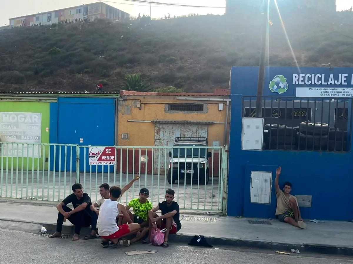 Moroccan illegal immigrants resting by a recycling plant in Ceuta, Spain, on Aug. 2, 2026. (Etienne Fauchaire/The Epoch Times)