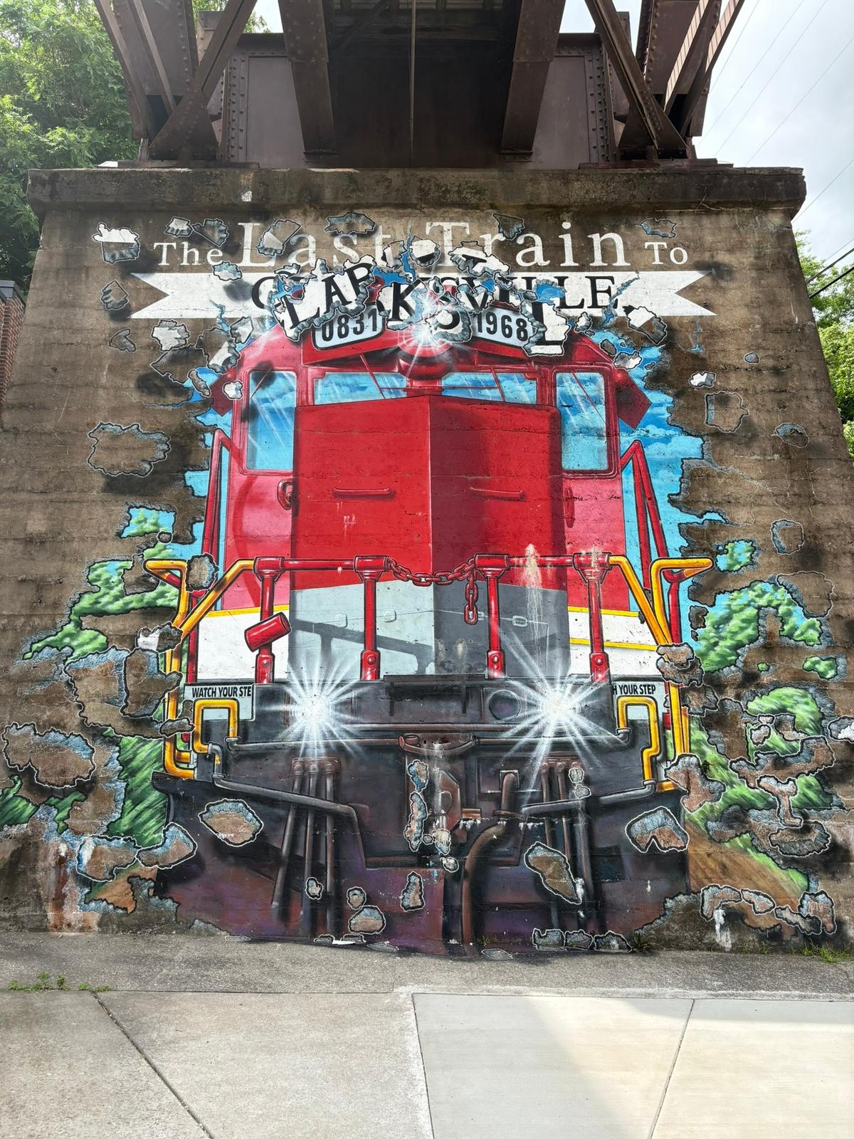 Artist Ricky Cavaness' "Last Train to Clarksville" mural bursts from the support pillar of the old train bridge in downtown Clarksville, Tennessee. (Photo courtesy of Alison Ramsey)