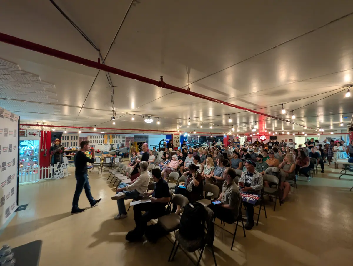 A staffer for the Abdul El-Sayed campaign gives canvassing instructions to attendees at a rally at the Michigan Firehouse Museum and Education Center in Ypsilanti, Mich., on July 30, 2026. (Jacob Burg/The Epoch Times)
