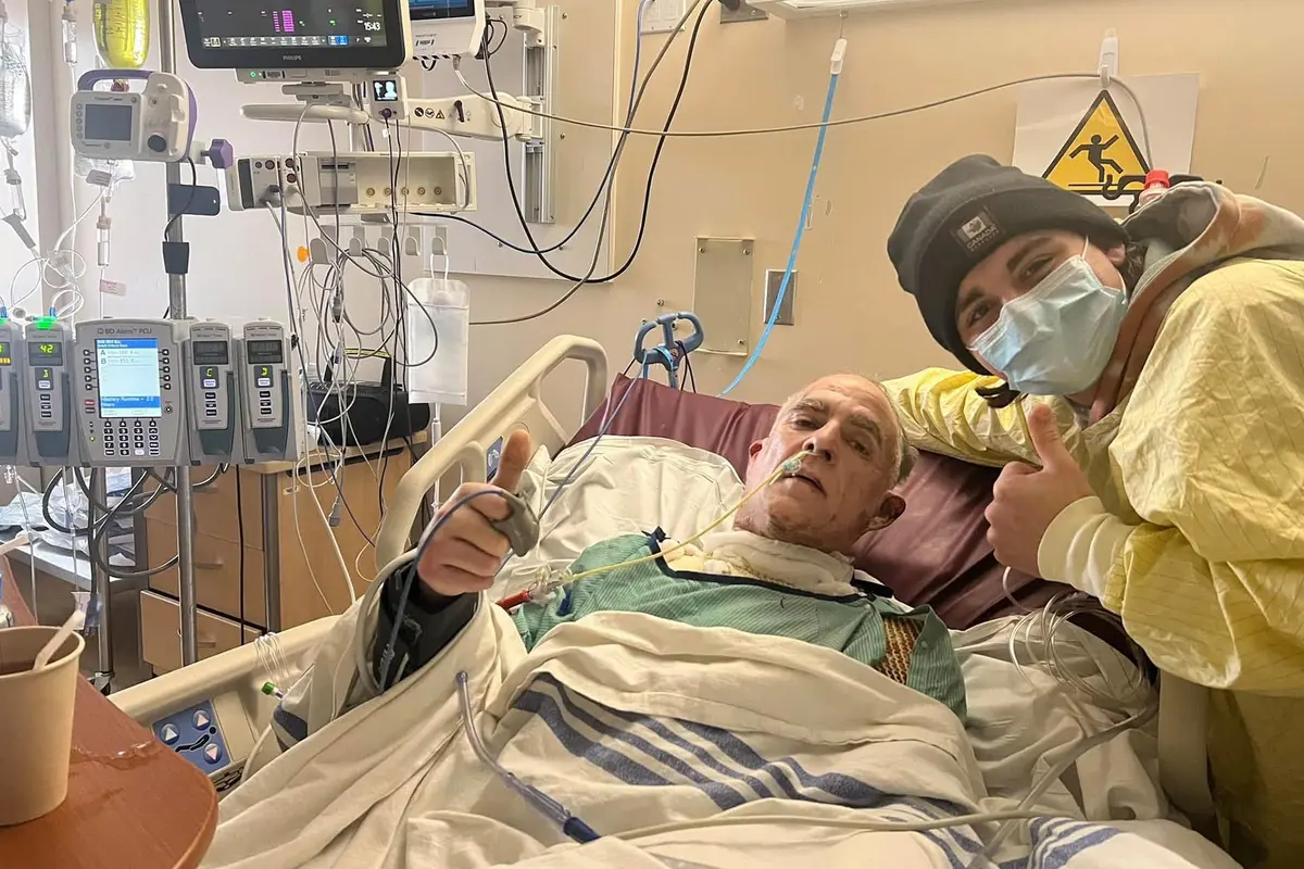 Zeke Fox and the then-53-year-old victim of the fire, Shawn Goodwin, pose in the hospital. (Courtesy of Christine Fox)