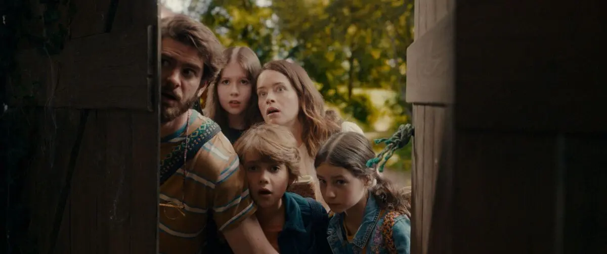 The Thompson family makes a discovery: (L-R) Dad Tim (Andrew Garfield), Beth (Delilah Bennett-Cardy), Mom Polly (Claire Foy), Joe (Phoenix Laroche), and Fran (Billie Gadsdon), in “The Magic Faraway Tree.” (Vertical)