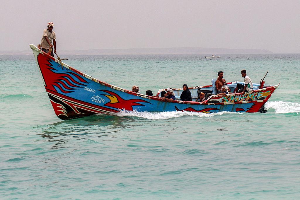 People sit in a fishing boat sailing the Bab el-Mandeb Strait off of Yemen's southern Taiz province on July 25, 2026. (Khaled Ziad/AFP via Getty Images)