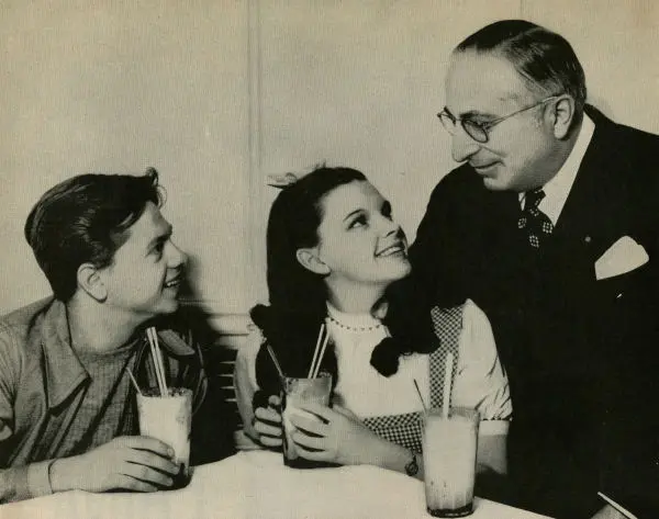 Mickey Rooney and Judy Garland greet Louis B. Mayer, circa 1938. (Public Domain)