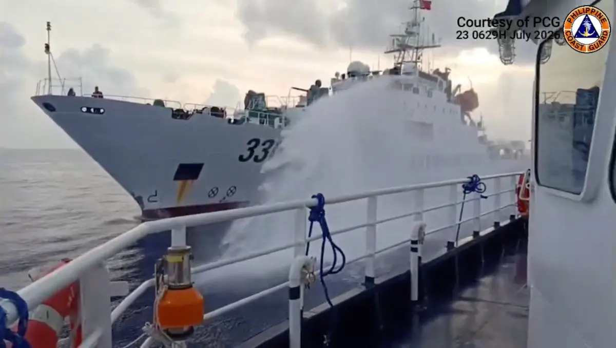 A Chinese coast guard ship fires a water cannon at a Philippine vessel in the South China Sea, in this screengrab taken from a handout video released on July 23, 2026. (Jay Tarriela via X/Handout via Reuters)