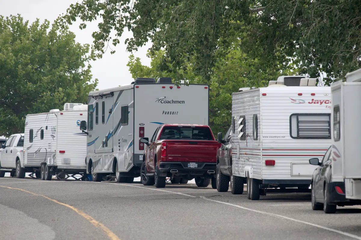 The RVs of people who have been forced from their homes by wildfires line Beach Ave. in Peachland, B.C., on Aug. 8, 2026. (The Canadian Press/Gary Nylander)