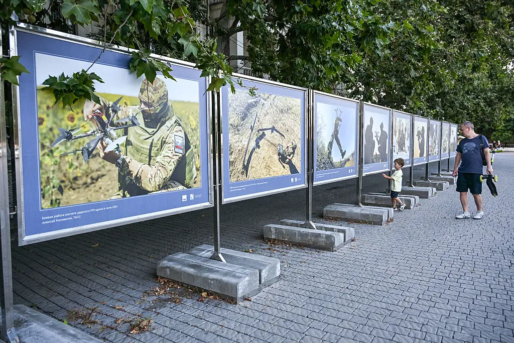 A man looks at photographs of an exhibition dedicated to Russia’s drone-operating troops in central Sevastopol, Crimea, on July 22, 2026. (Igor Ivanko/AFP via Getty Images)