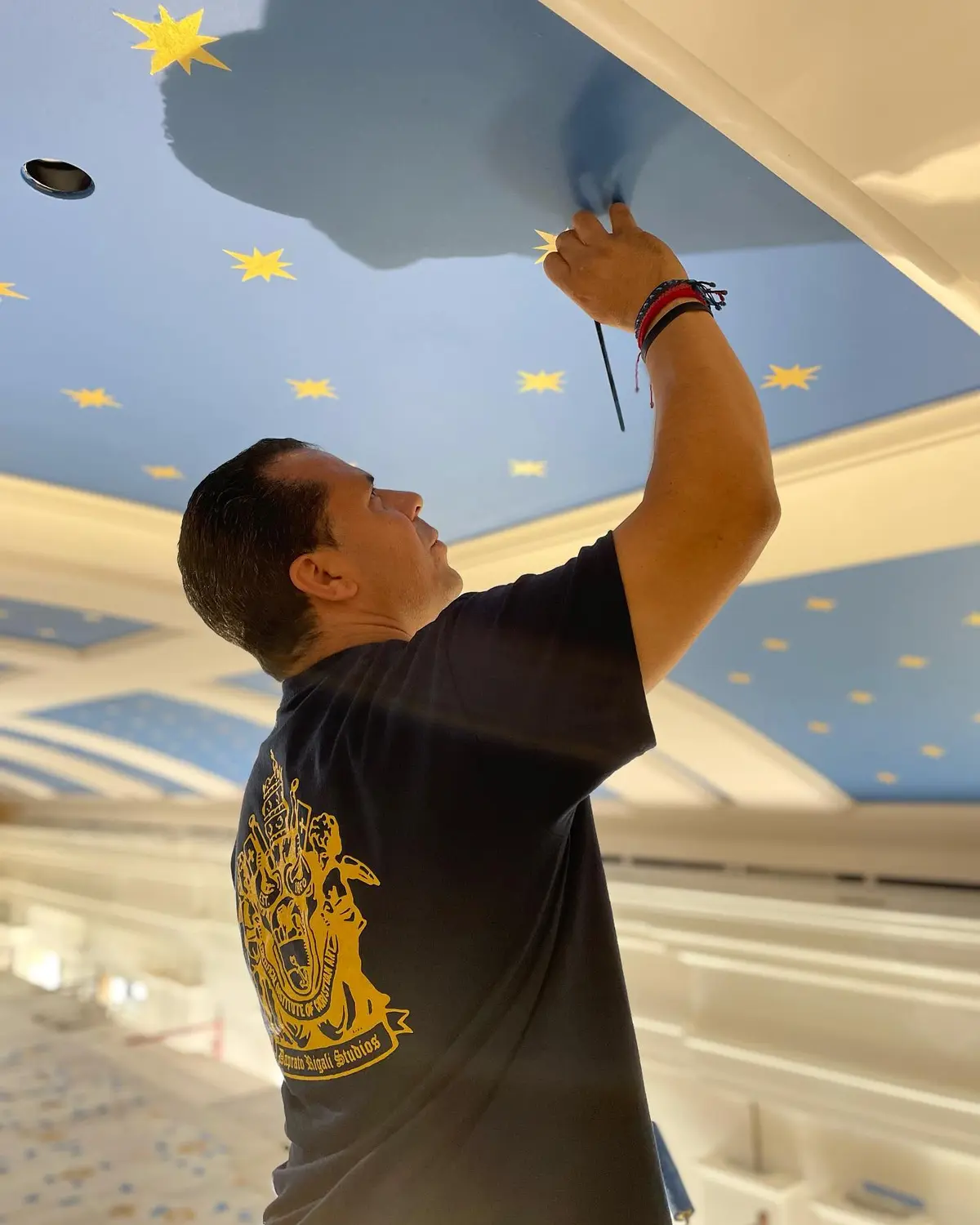 A Daprato Rigali Studios crew member paints stars on the ceiling of St. Theresa Catholic Church in Palatine, Ill. (Courtesy of Daprato Rigali Studios)