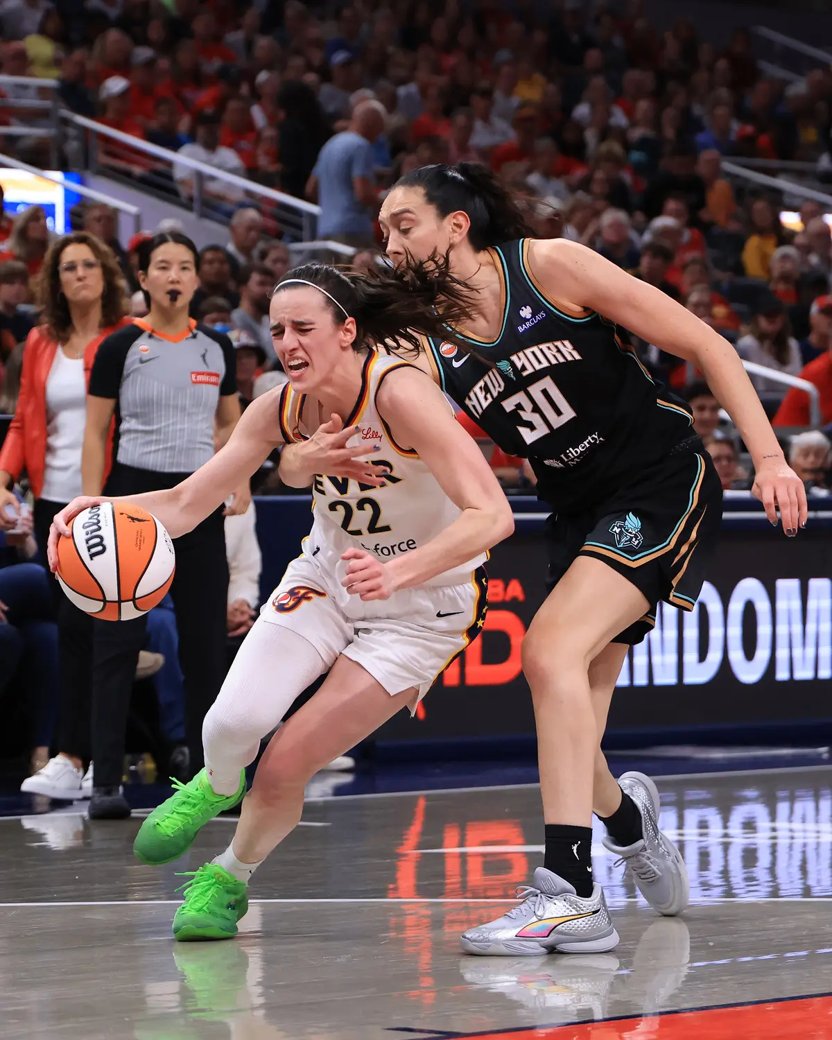 Caitlin Clark (22) of the Indiana Fever is fouled by Breanna Stewart (30) of the New York Liberty during the first half at Gainbridge Fieldhouse in Indianapolis on Aug. 11, 2026. (Justin Casterline/Getty Images)