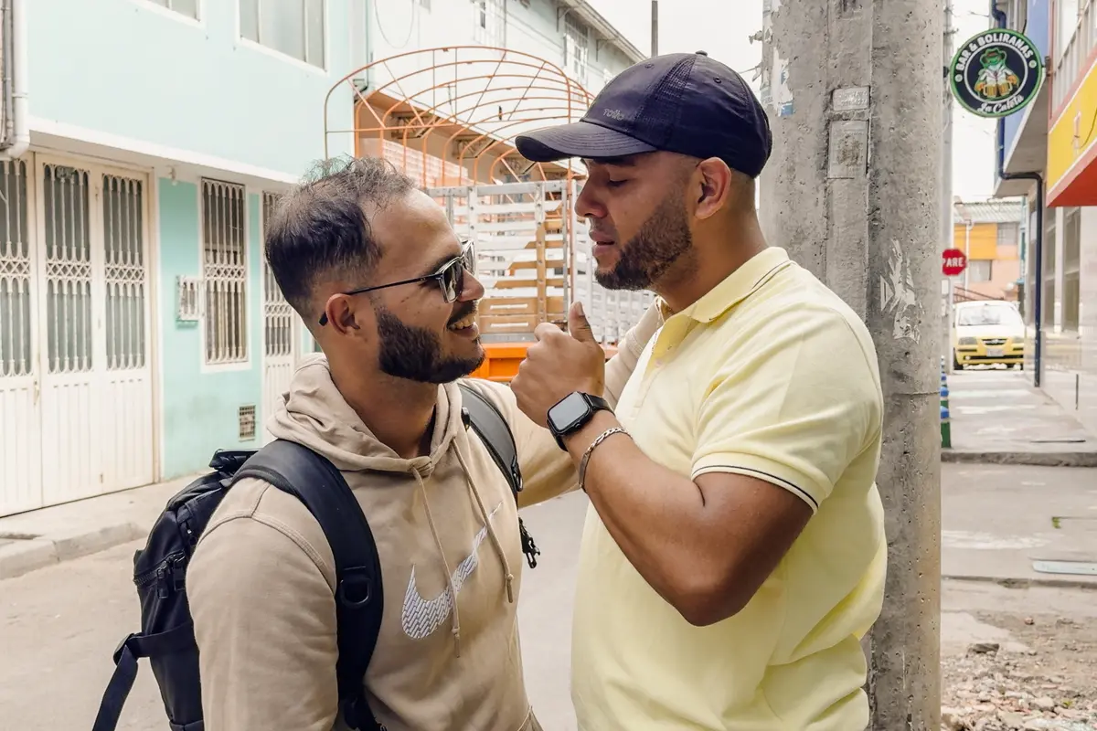 Venezuelan brothers Carlos José Leon (L) and Yarvis Hoyos greet each other for the first time in nearly nine years. In 2018, Leon fled Venezuela to live in Brazil and Hoyos fled to Colombia, in Bogotá, Colombia, on July 5, 2026. (Frederico Vidovix/The Epoch Times)