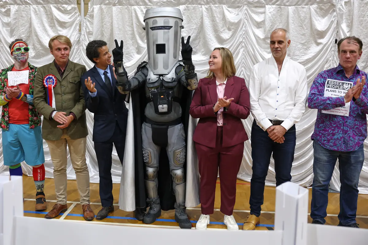 Count Binface (C) stands among other candidates during the result announcement after the Clacton by-election count at a leisure center in Clacton-on-Sea, England, on Aug. 14, 2026. (Richard Pelham/AP Photo)