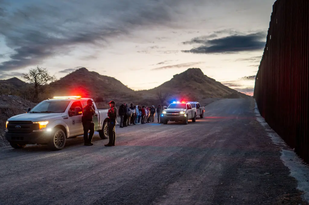 Illegal immigrants from Mexico and Guatemala are apprehended by U.S. Border Patrol officers after crossing a section of border wall into Ruby, Arizona, on Jan. 4, 2025. (Brandon Bell/Getty Images)