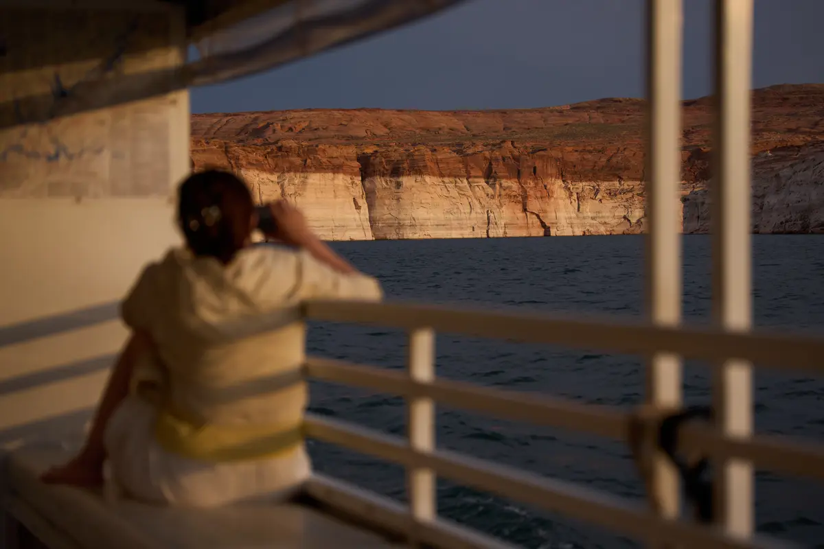 A person takes a picture during a tour on Lake Powell at the Glen Canyon National Recreation Area, near Page, Ariz., on July 15, 2026. (John Locher/AP)