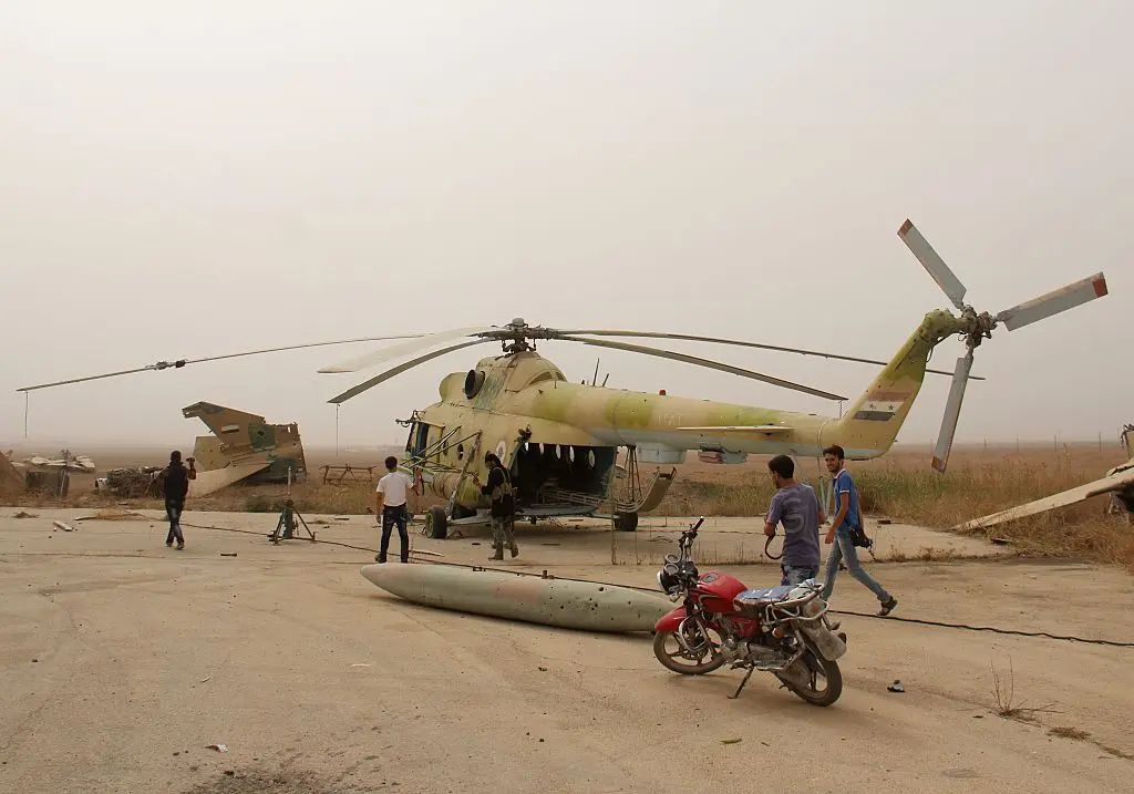 Journalists take photos of members of Al-Qaeda's Syrian affiliate and its allies after they seized the Abu Duhur military airport in northwestern Idlib province on Sept. 9, 2015. (Omar Haj Kadour/AFP Photo)