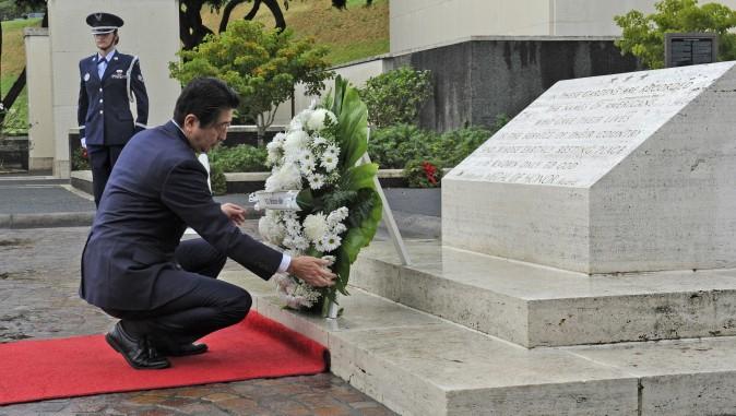 Japanese Prime Minister Shinzo Abe visits the National Memorial Cemetery of the Pacific to place a wreath at the Honolulu Memorial, in Honolulu on Dec. 26, 2016. (Bruce Asato/The Star-Advertiser via AP)