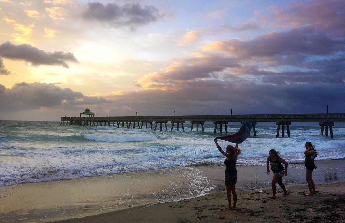 People view a sunrise on a windy day at Deerfield Beach, Fla., on April 18. (Rolando Otero/South Florida Sun-Sentinel via AP)