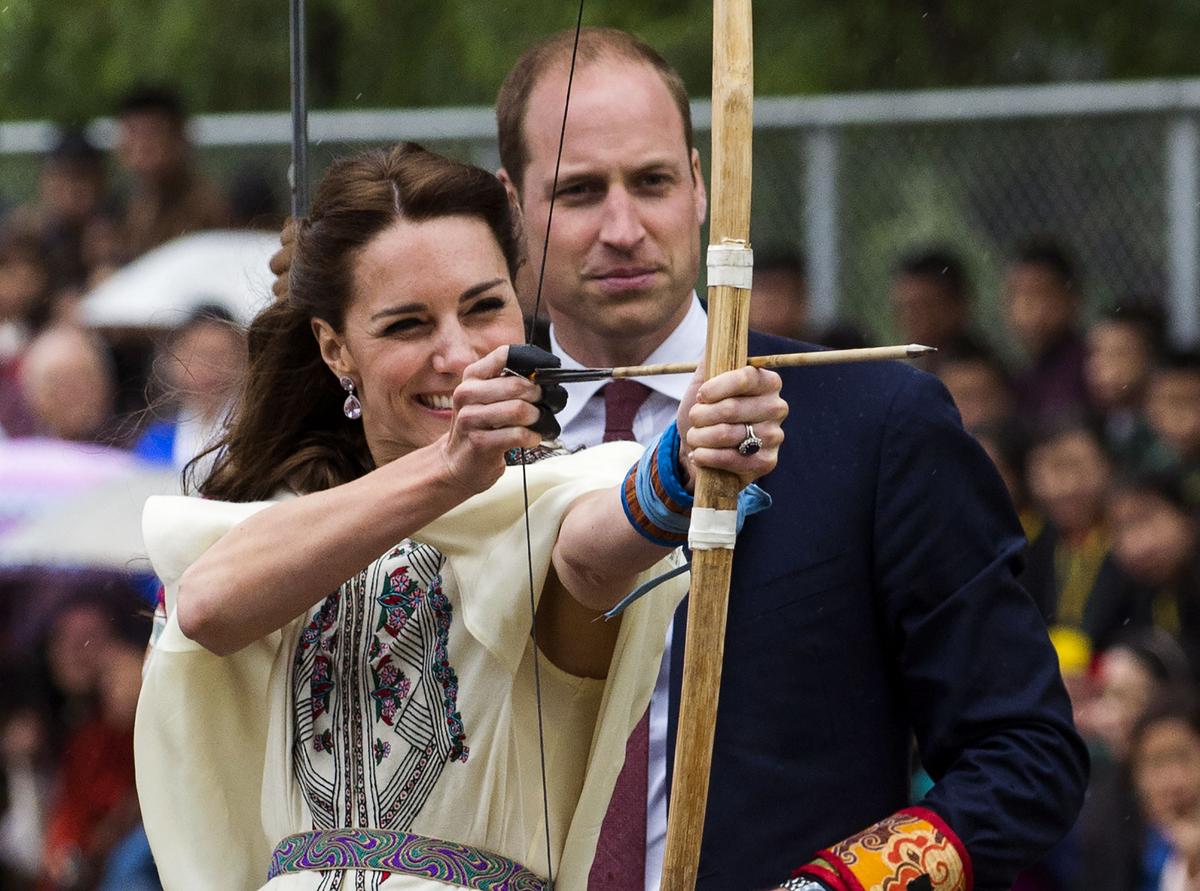 Britain's Catherine, the Duchess of Cambridge, fires an arrow with Prince William, Duke of Cambridge, lat the Changlingmethang National Archery ground in Thimphu during their visit to Bhutan on April 14. (Roberto Schmidt/AFP/Getty Images)