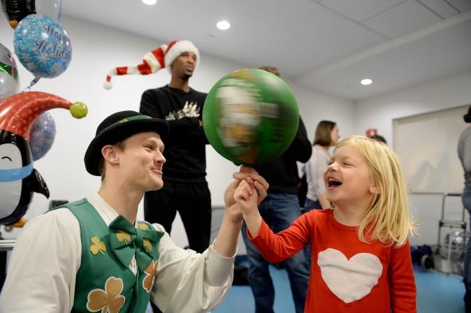 Boston Celtics mascot Lucky hangs with Grace at Boston Children's Hospital on Dec. 1. (Darren McCollester/Getty Images for Boston Children's Hospital)