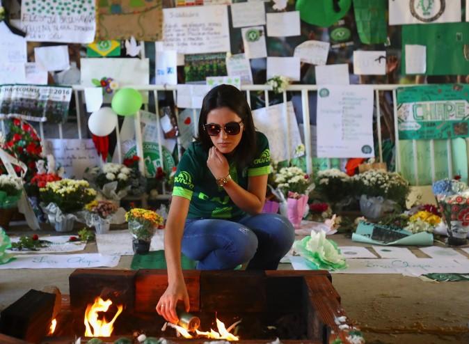 A fan pays tribute to the players of Brazilian team Chapecoense Real at the club's Arena Conda stadium in Chapeco, in the southern Brazilian state of Santa Catarina, on Dec. 1. The players were killed in a plane accident in the Colombian mountains. Players of the Chapecoense team were among the 77 people on board the doomed flight that crashed into mountains in northwestern Colombia. (Buda Mendes/Getty Images)
