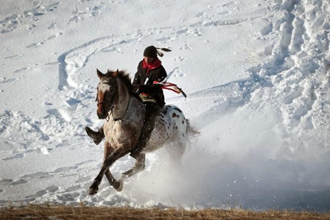 An Native American activist rides down from a ridge which overlooks the Standing Rock Sioux Reservation outside Cannon Ball, N.D., on Dec. 4. Native Americans and activists from around the country have been gathering at the camp for several months trying to halt the construction of the Dakota Access Pipeline. The proposed 1,172-mile-long pipeline would transport oil from the North Dakota Bakken region through South Dakota, Iowa and into Illinois. (Scott Olson/Getty Images)