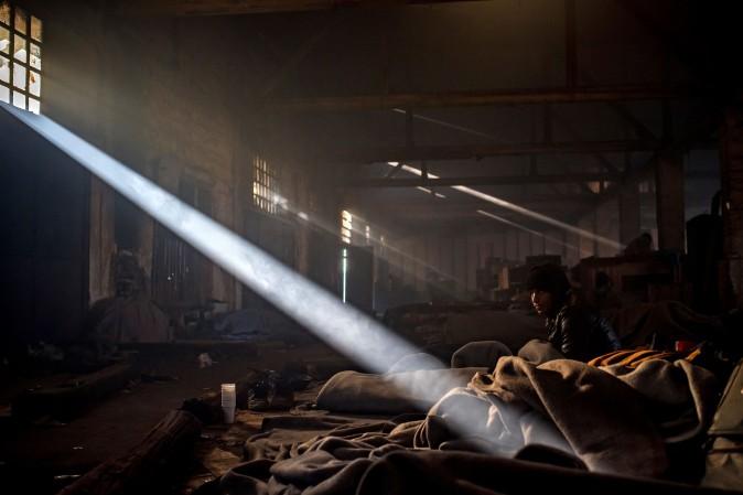 A migrant sits in a makeshift shelter at an abandoned warehouse in Belgrade, Serbia, on Dec. 8, 2016. According to the latest figures, 6,300 migrants are stranded in Serbia. (Andrej Isakovic/AFP/Getty Images)