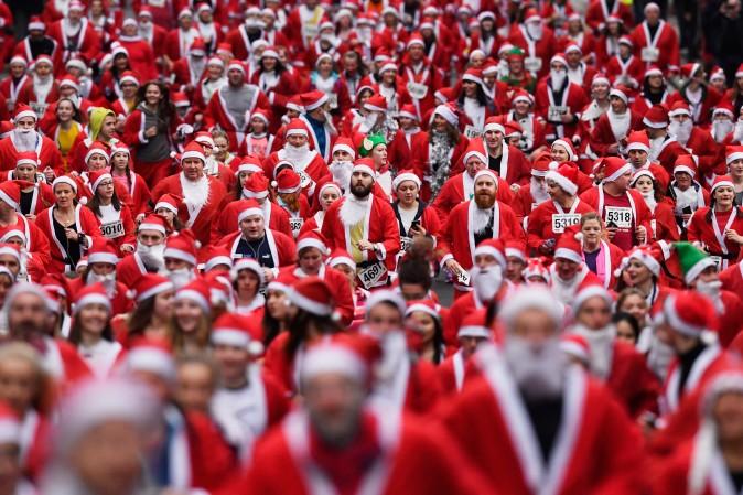 Over seven thousands people take part in the annual Santa Dash in Glasgow, Scotland, on Dec. 11, which has raised over $125,000 for charities since its inception in 2006. (Jeff J Mitchell/Getty Images)