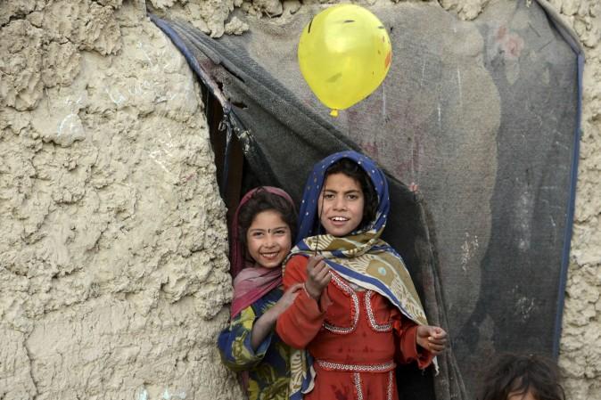 Internally displaced children play outside their temporary home at a refugee camp in Kabul, Afghanistan, on Dec. 16, 2016. (Noorullah Shirzada/AFP/Getty Images)