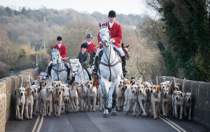 Joint Master and Huntsman Stuart Radbourn (C) leads riders for The Avon Vale Hunt's traditional Boxing Day meet in Lacock Village, England, on Dec. 26, 2016. Boxing Day is traditionally the biggest day in the fox hunt calendar. (Matt Cardy/Getty Images)
