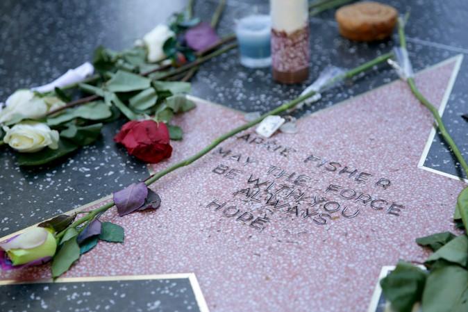 Carrie Fisher is remembered with a makeshift star on the Hollywood Walk of Fame in Hollywood, Calif., on Dec. 28. The star was reportedly made by a fan who added Fisher's name to a blank star along with the words "may the force be with you always" and "hope." Fisher was never nominated for a star while living and now won't be eligible until the fifth anniversary of her death. (Greg Doherty/Getty Images)