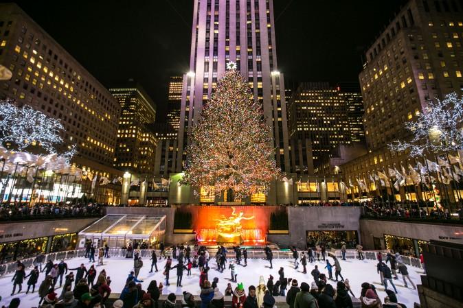 People ice skate under the decorative Norway spruce tree at the Rockefeller Center plaza on Dec. 19, which brings over 125 million visitors each year to see the city's most renowned Christmas tree. (Benjamin Chasteen/Epoch Times)
