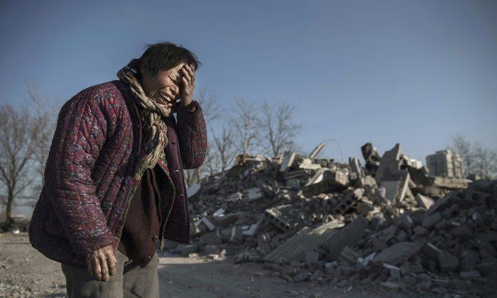 Zheng Yuzhi, whose apartment was demolished by authorities three months ago and is now homeless, in an area once filled with housing for migrant workers, in the Changing District of Beijing, China, on December 5, 2017. (Kevin Frayer/Getty Images)