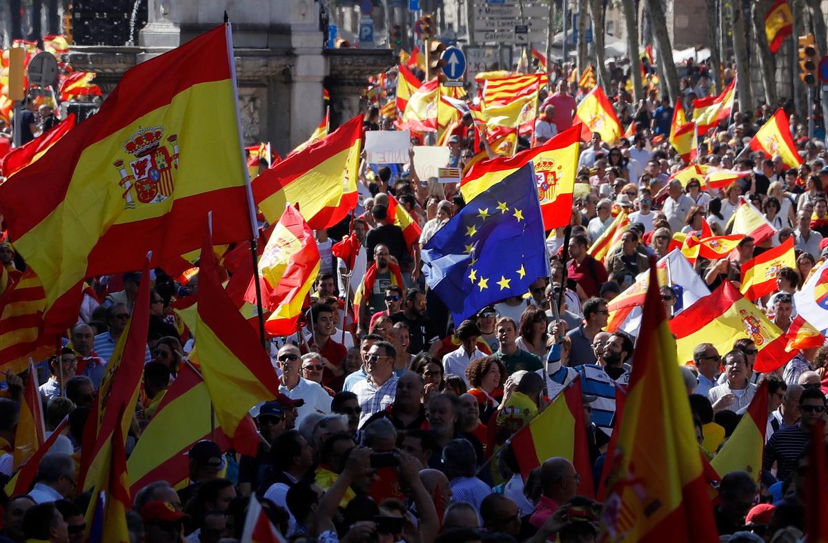 An EU flag is seen amongst Spanish flags during a pro-union demonstration organised by the Catalan Civil Society organisation in Barcelona, Spain October 8, 2017. REUTERS/Eric Gaillard