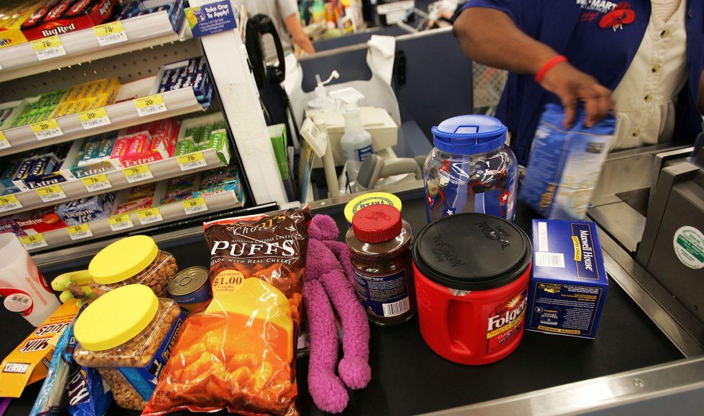 Groceries and other retail items move down the checkout counter of a Wal-Mart Supercenter May 11, 2005, in Troy, Ohio. (Chris Hondros/Getty Images)