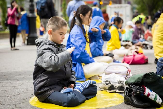 A young Falun Dafa practitioner participates at the World Falun Dafa Day event at Union Square, New York City, on May 11, 2017. (Samira Bouaou/The Epoch Times)