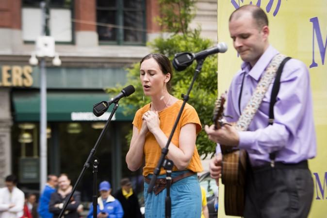 Katy Mantyk and Nemanja Rebic sing a song about the persecution of Falun Dafa practitioners inside China during the World Falun Dafa Day event held at Union Square, New York City, on May 11, 2017. (Samira Bouaou/The Epoch Times)