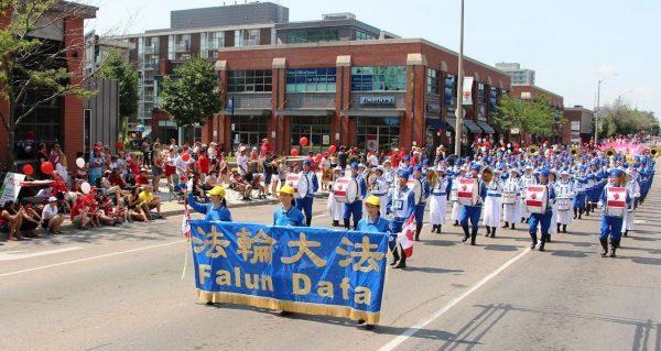 Falun Dafa practitioners of the Tian Guo Marching Band participate in the Canada Day parade in Toronto on July 1, 2018. The author joined the Tian Guo band soon after arriving in Canada. (Minghui.org)