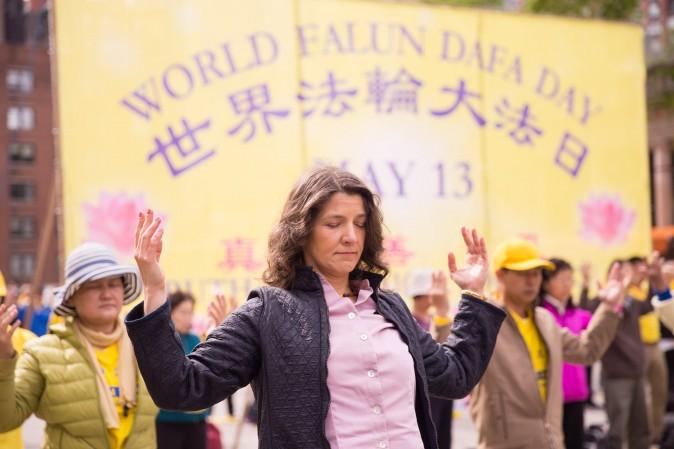 People perform the Falun Dafa exercises during the World Falun Dafa Day event at Union Square, New York City, on May 11, 2017. (Larry Dye/The Epoch Times)