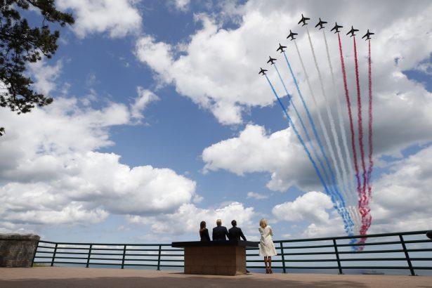 President Donald Trump, First Lady Melania Trump, French President Emmanuel Macron and French First Lady Brigitte Macron, watch a flyover during a ceremony to commemorate the 75th anniversary of D-Day at the American Normandy cemetery in Colleville-sur-Mer, Normandy, France, on June 6, 2019. (Alex Brandon/AP Photo)