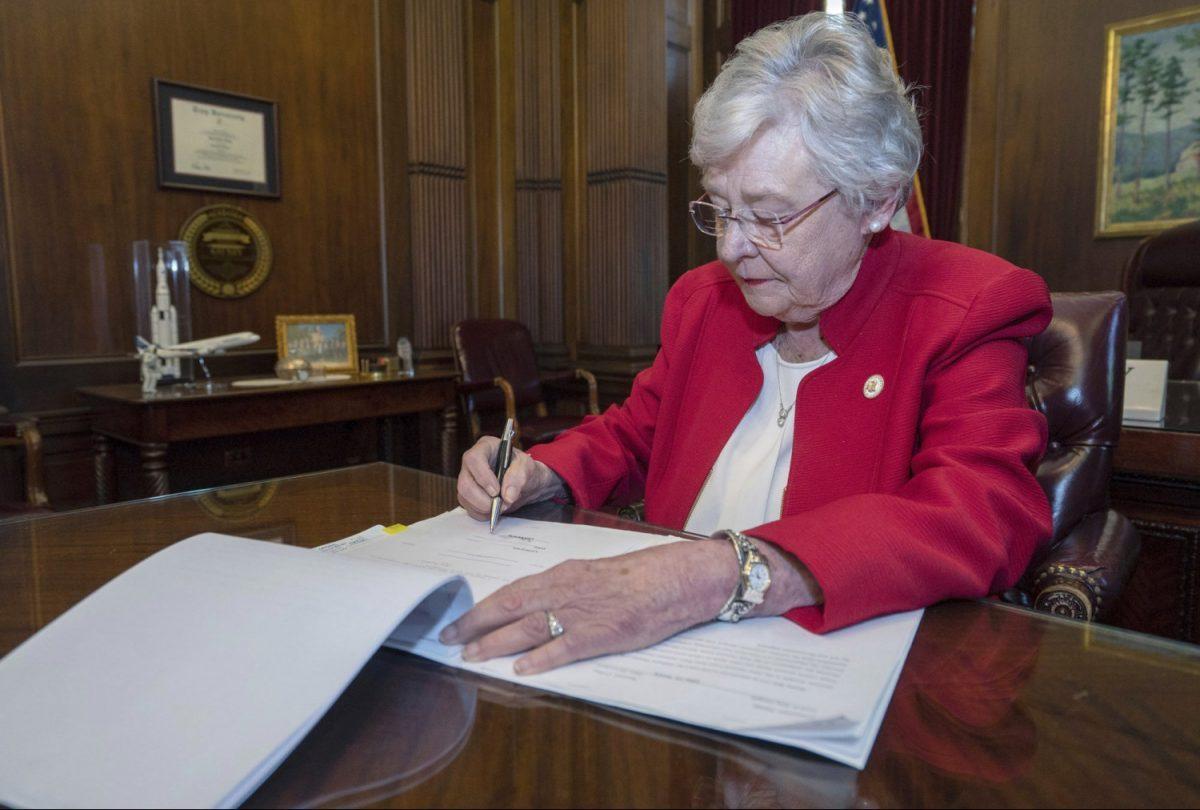 Alabama Gov. Kay Ivey signs into law the Alabama Human Life Protection Act, after both houses of the legislature passed the bill, in Montgomery, Ala., in a file photograph. (Office of the Governor State of Alabama/Handout via Reuters)