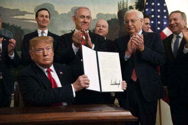President Donald Trump holds up a signed proclamation recognizing Israel's sovereignty over the Golan Heights, as Israeli Prime Minister Benjamin Netanyahu looks on in the Diplomatic Reception Room of the White House, on March 25, 2019. (Susan Walsh/AP Photo)