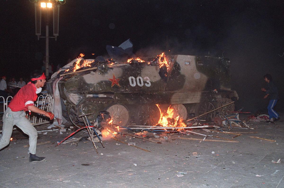 An armoured personnel carrier is in flames as students put in on fire 04 June 1998 near Tiananmen Square in Beijing. On the night of 03 and 04 June 1989, Tiananmen Square (TOMMY CHENG/AFP/Getty Images)