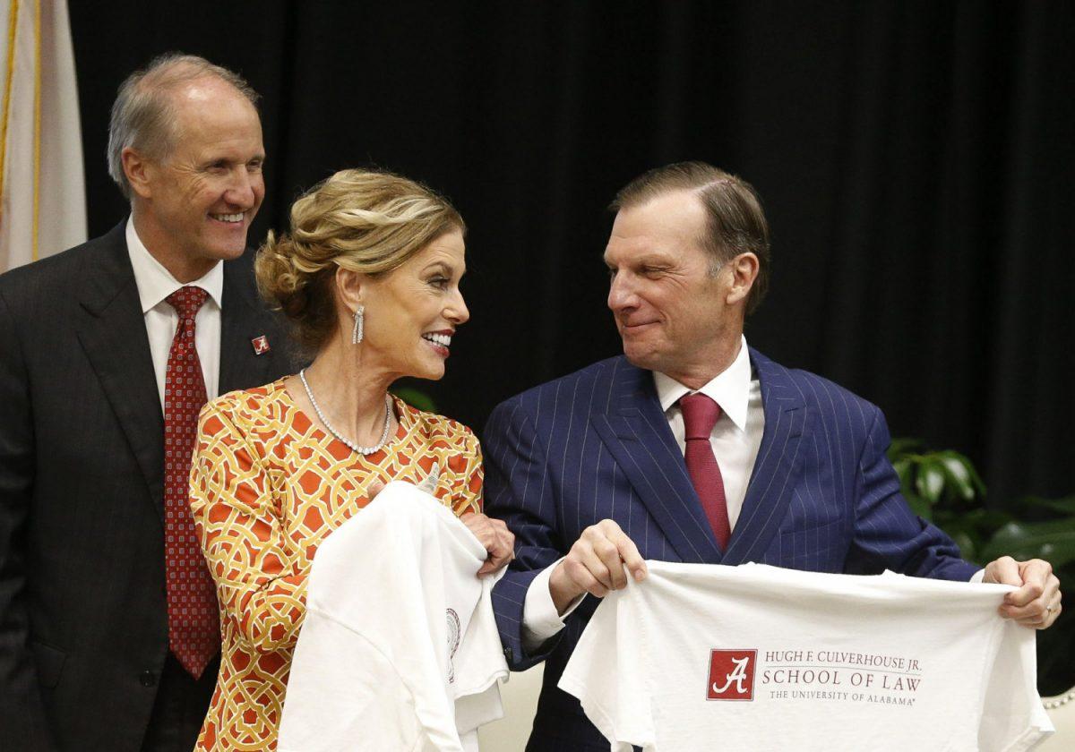 Hugh F. Culverhouse Jr., right, and wife, Eliza, in Tuscaloosa, Ala., show off T-shirts from the University of Alabama law school, which now bears his name. (Gary Cosby Jr./The Tuscaloosa News via AP)