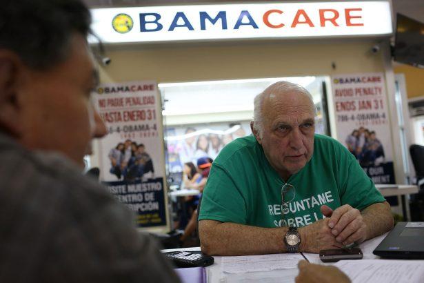 Antonio Galis, an insurance agent from Sunshine Life and Health Advisors, discusses with a client plans available in the third year of the Care Act at a store setup in the Mall of the Americas in Miami, Fla., on Nov. 2, 2015. (Joe Raedle/Getty Images)