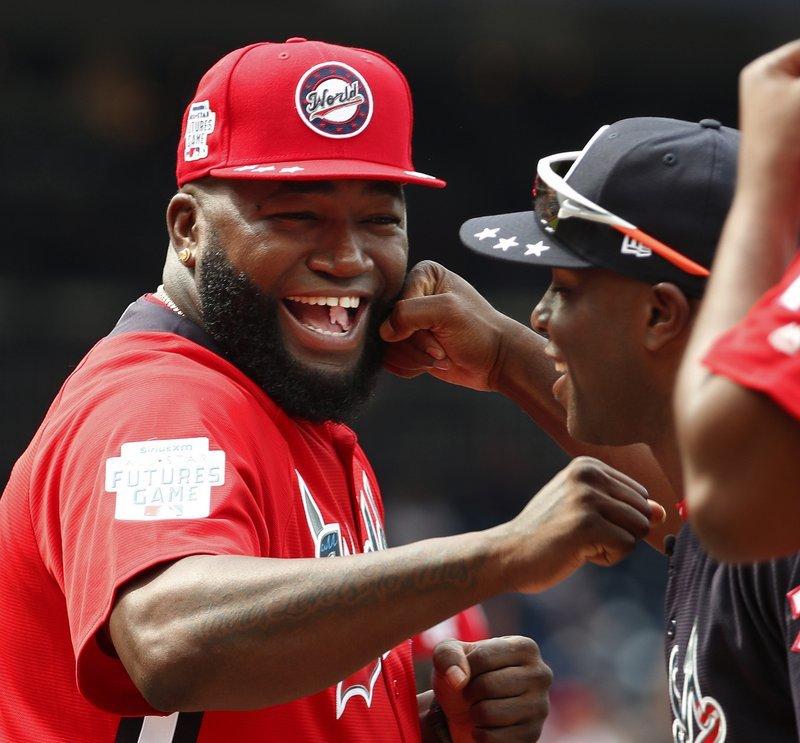 World Team Manager David Ortiz (34) speaks with U.S. Team Manager Torrii Hunter, before the All-Star Futures baseball game at Nationals Park, in Washington, on July 15, 2018. (Alex Brandon/AP Photo)