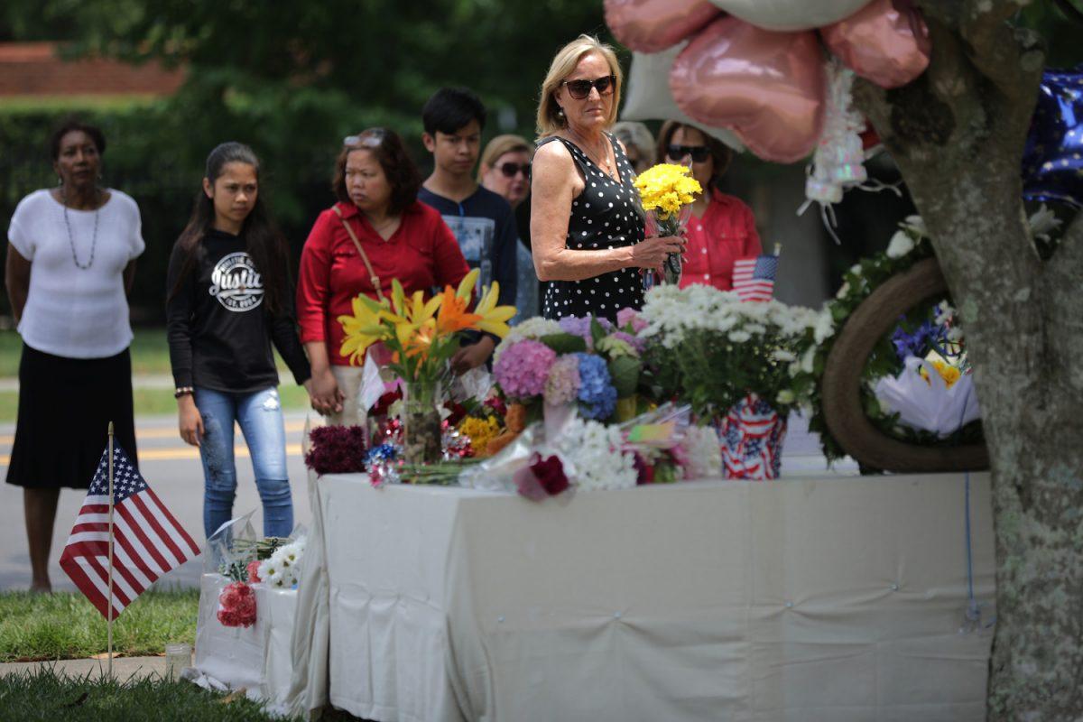 People place flowers at a makeshift memorial for the 12 victims of a mass shooting at the Municipal Center in Virginia Beach, Va., on June 2, 2019. (Chip Somodevilla/Getty Images)