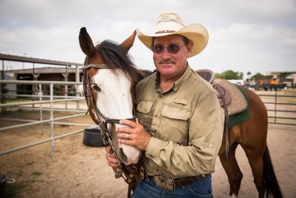 Border Patrol Supervisory Agent Jeff Wiggins with Santos, one of the horses trained to be on horse patrol in Edinburg, Texas, on May 26, 2017. (Benjamin Chasteen/The Epoch Times)