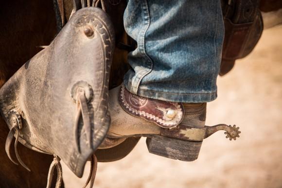 A boot and spur in a stirrup shows the Border Patrol logo. The stirrups and breast collars are made by Colorado inmates. (Benjamin Chasteen/The Epoch Times)