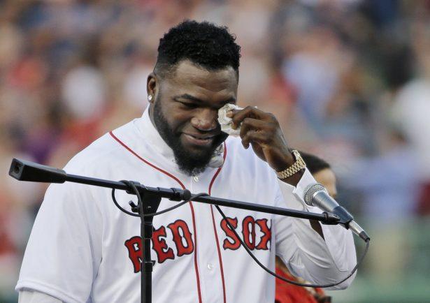 Boston Red Sox baseball great David Ortiz wipes a tear at Fenway Park in Boston as the team retires his number "34" worn when he led the franchise to three World Series titles on June 23, 2017. (Elise Amendola/AP Photo)