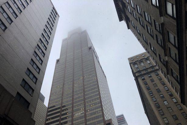 Mist and smoke cover the top of a building near 51st Street and 7th Avenue on June 10, 2019, in New York, where a helicopter was reported to have crash landed on top of the roof of a building in midtown Manhattan. (AP Photo/Mark Lennihan)