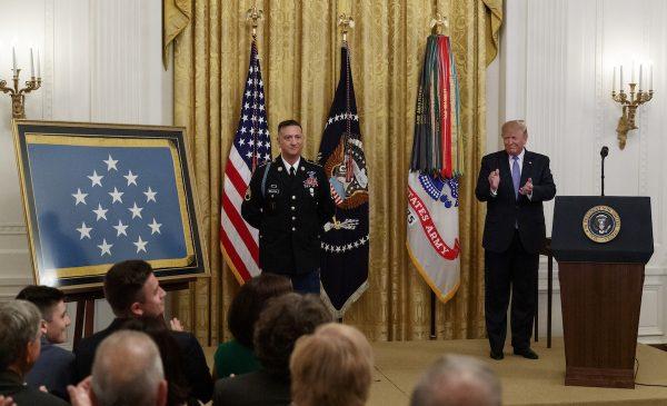 President Donald Trump applauds during a ceremony to award the Medal of Honor to Army Staff Sgt. David Bellavia in the East Room of the White House in Washington, on June 25, 2019. (Carolyn Kaster/AP Photo)